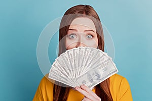 Portrait of shocked funny rich lady hold fan banknotes on blue background