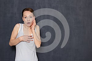 Portrait of shocked girl with widened eyes and open mouth