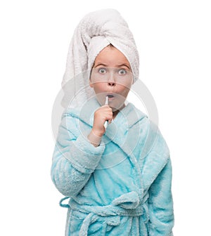 portrait of shocked little girl wearing bathrobe with towel on h