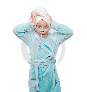 portrait of shocked little girl wearing bathrobe with towel on h