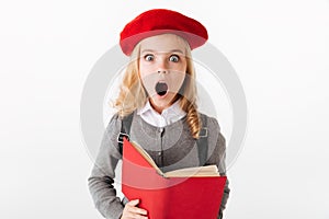 Portrait of a shocked little schoolgirl dressed in uniform