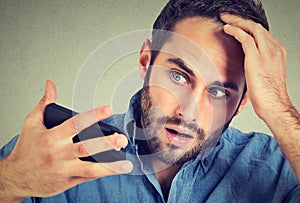 Portrait, shocked man feeling head, surprised he is losing hair