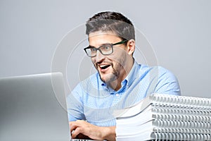 Portrait of shocked man sitting at the table with laptop
