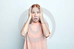 Portrait of shocked scared young woman having panic expression