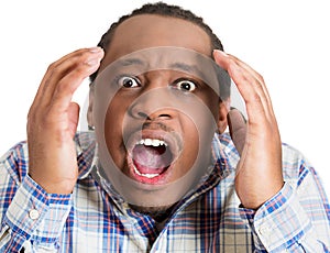 portrait shocked, stunned, surprised young man eyes, mouth wide open, hands in air yelling, screaming, shouting, isolated white photo