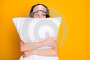 Portrait of shocked terrified girl see nightmare embrace her soft pillow look copyspace wear pajama eye mask isolated