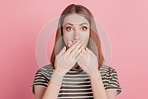 Portrait of shocked voiceless blonde lady crossed palms cover mouth on pink background photo