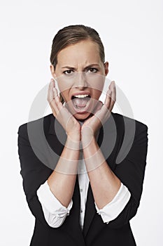 Portrait of shocked young businesswoman