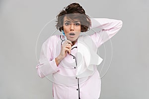 Portrait of a shocked young girl in pajamas and towel