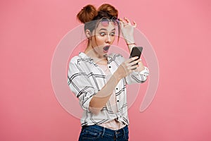 Portrait of a shocked young girl using mobile phone