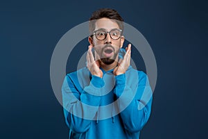 Portrait Of Shocked Young Man Opening Mouth And Looking At Camera