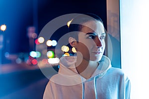 Portrait of a short haired woman at night in the city