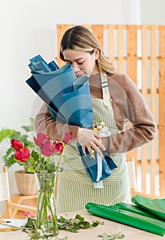 Portrait shot of Asian professional successful female florist designer shop owner entrepreneur businesswoman in apron standing