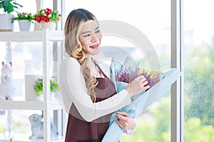 Portrait shot of Asian professional successful female florist designer shop owner entrepreneur businesswoman in apron standing