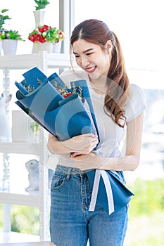 Portrait shot of Asian professional successful female florist designer shop owner entrepreneur businesswoman in apron standing