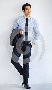 Portrait shot of Asian young charming success smart businessman model take black formal suit jacket uniform off hold on arm