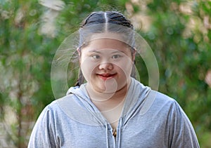Portrait shot of Asian young chubby down syndrome autistic autism little cute schoolgirl with braid pigtail hairstyle model stand