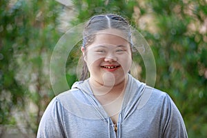 Portrait shot of Asian young chubby down syndrome autistic autism little cute schoolgirl with braid pigtail hairstyle model stand