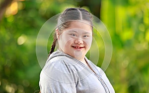 Portrait shot of Asian young chubby down syndrome autistic autism little cute schoolgirl with braid pigtail hairstyle model stand