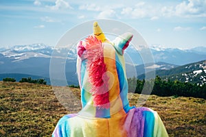 Feel freedom concept in mountains, woman traveling in a unicorn