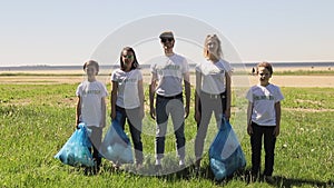 Portrait shot of caucasian happy responsible family standing outdoors with plastic bottle litter bags Spbi.