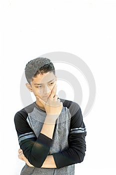 Portrait shot of a Caucasian teenager wearing a black colored full sleeves t-shirt and expressing doubtfulness on his face.Isolate