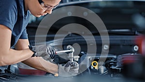 Portrait Shot of a Female Mechanic Working on a Vehicle in a Car Service. Empowering Woman Fixing