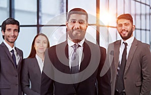 portrait shot of smiling business team of four standing and smiling