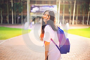 Portrait shot of young Asian female student smiling outdoor