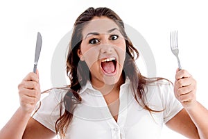 Portrait of shouting woman with fork and knife