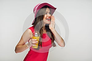 Portrait of shouting woman holding glass with orange juice.