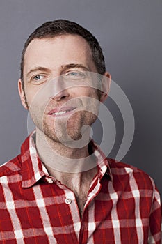 Portrait of shy 40s man wearing goatee and checked shirt