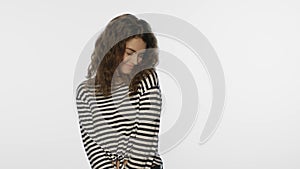 Portrait of shy woman on white background. Shy girl in studio. Young woman