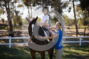 Portrait of sibling with horse