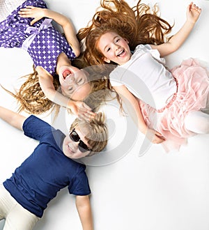 Portrait of siblings lying on a white background