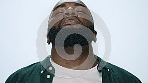 Portrait of sick african american handsome sneezing on light background.