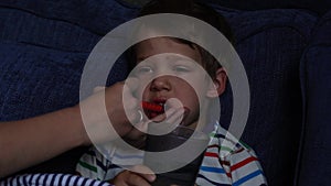 Portrait of sick ill little preschool child boy.Kid is drinking waer. Take medicine curing syrup antipyretic. Children