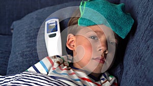 Portrait of sick ill little preschool child boy. Measuring body Hight temperature. Taking medicine curing syrup