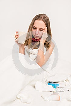 Portrait of sick woman with grippe and headache holding cup of hot tea photo