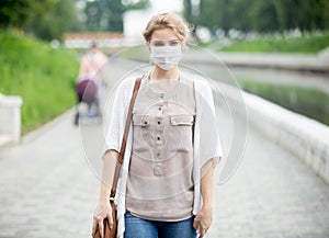 Portrait of sick woman wearing protective mask against infective diseases