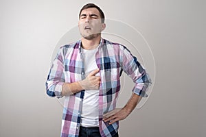 Portrait of sickly man holding his heart