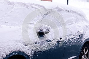 A portrait of the side of a car full of snow which is badly cleared. the driver should wait for the snow and ice to melt or clear