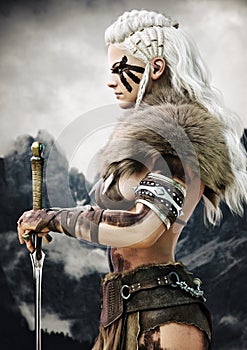 Portrait side view of a fierce viking female warrior with white braided hair and black face paint markings.