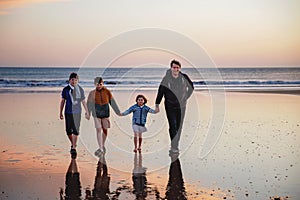 Portrait silhouettes of three children and dad happy kids with father on beach at sunset. happy family, Man, two school