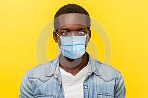 Portrait of silly crazy man with surgical medical mask crossing eyes looking at his nose, fooling around and he stay crazy of news