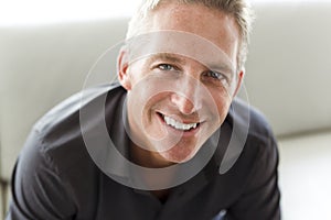 Portrait of single 40s man sitting in sofa