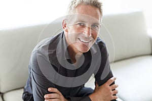 Portrait of single 40s man sitting in sofa