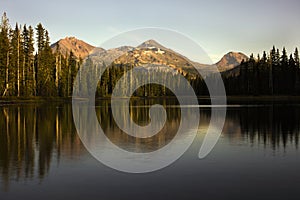 Portrait of the Sisters mountains at Scott lake during the fall of 2022