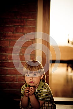 Portrait of sitting a boy with worried look