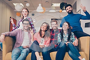 Portrait of six young happy smiling best friends sitting on couch